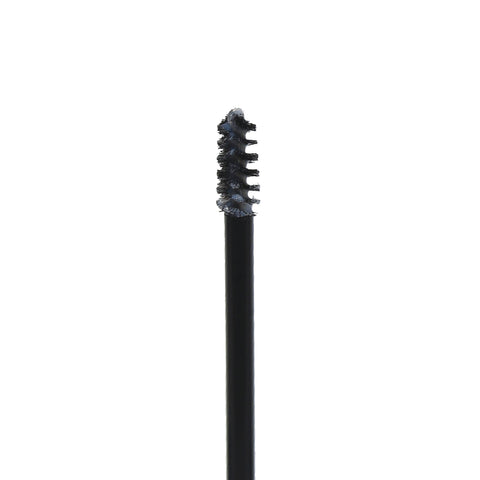 Close-up of the mini spoolie wand of Get-Fluffed Brow Gel, coated with tinted brow gel, ready to shape and set your eyebrows.