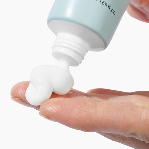 thick white cream coming out of tube of biome boost cream collagen moisturizer 