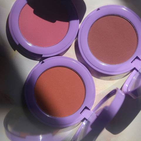 open purple compacts with pink orange and brown pans - In Bloom Powder Blush - Half Caked