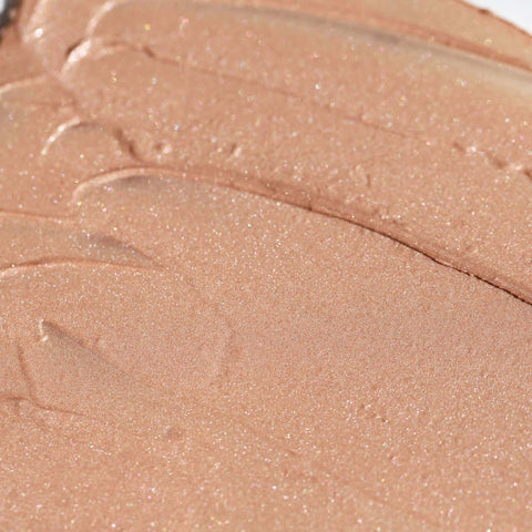 Close-up of a smudge of Candy Paint Cream Highlighter, showcasing its smooth, blendable texture for a dewy, radiant finish.