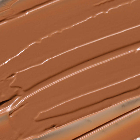 Creamy Candy Paint Cheek + Lip Tint in a warm, dewy finish, shown in a close-up swatch to highlight the product's smooth texture and blendable nature.