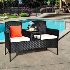 Rattan Cushioned Loveseat with Attached Glass Table